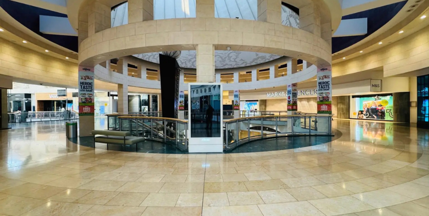 Spacious commercial interior with wall displays and print media.