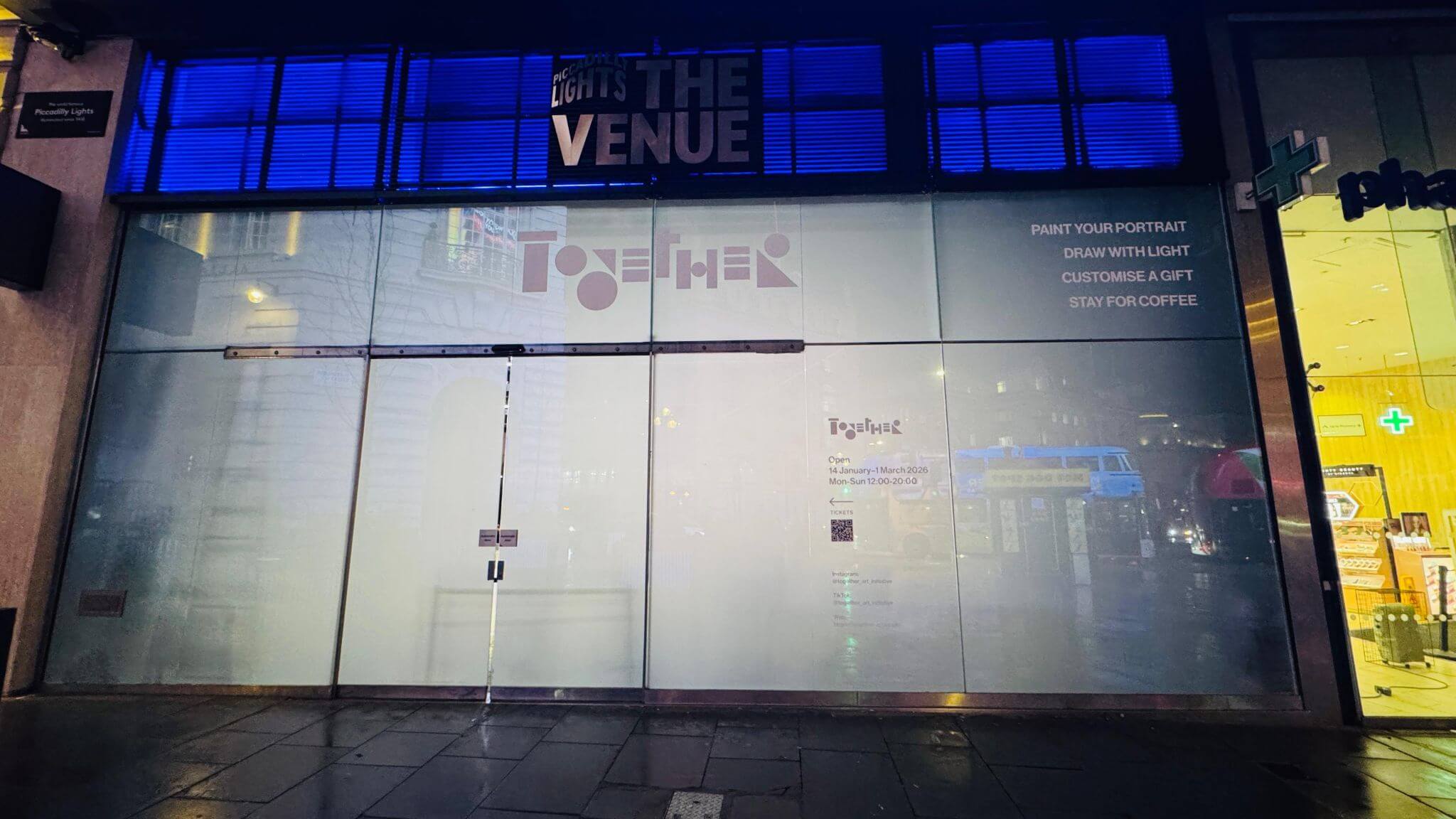 Temporary window graphics installed across a commercial storefront at Piccadilly Circus