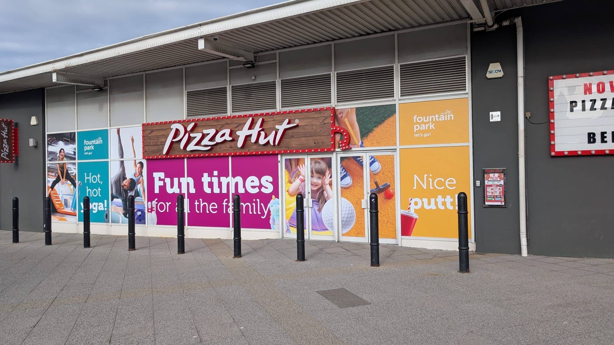 Retail storefront featuring colourful window manifestation graphics
