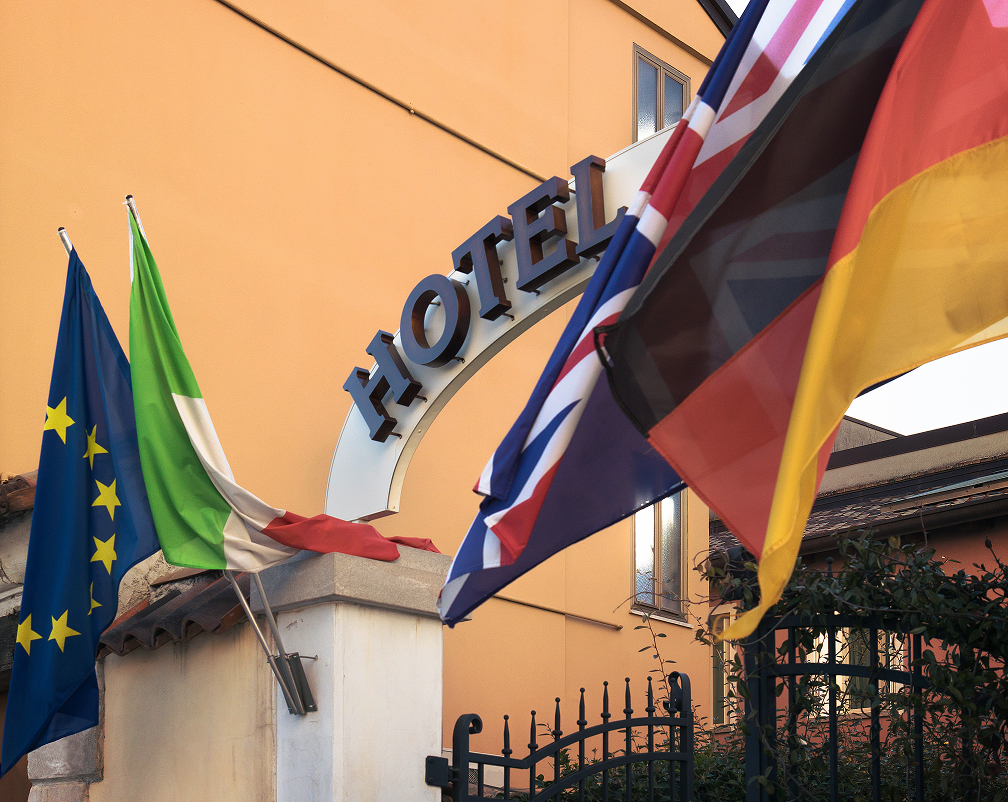 Hotel building with flags, representing the hospitality and tourism industry.